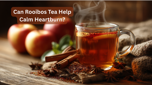cup of rooibos tea with apples in the background on a table